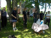 People standing around a table. Photo. 