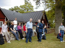 People standing outside a house. Photo.