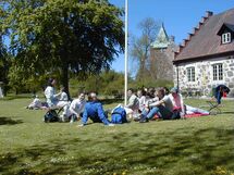 People relaxing in the grass. Photo.