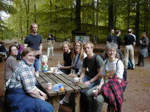 People drinking coffee in the nature. Photo. 