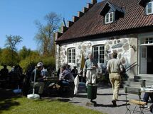 People outside a house. Photo.