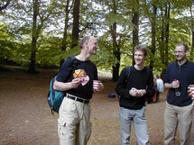 Three persons in the forest. Photo.