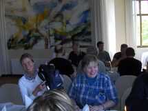 People sitting at a table, eating. Photo. 