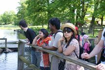 People looking at water. Photo. 