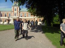 People walking in front of a building. Photo.