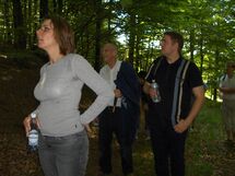 Three people in the forest. Photo.