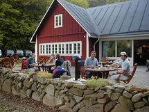 People having lunch outside a building. Photo. 