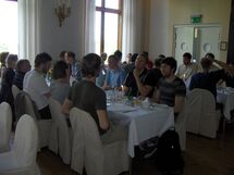 People sitting at a table, eating. Photo. 